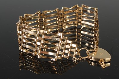 Lot 485 - A 9ct gold gatelink bracelet with heart shaped...