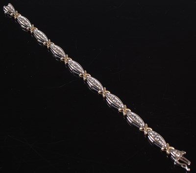 Lot 440 - A white and yellow metal diamond set bracelet...
