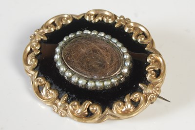 Lot 447 - A gold plated split pearl and black enamel...