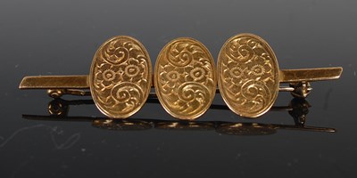 Lot 450 - A yellow metal bar brooch, set with three 9ct...