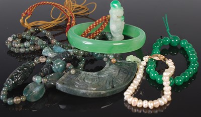 Lot 499 - A Chinese jadeite pendant carved with chilong,...