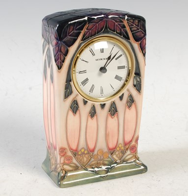 Lot 532 - A Moorcroft pottery table clock, with circular...