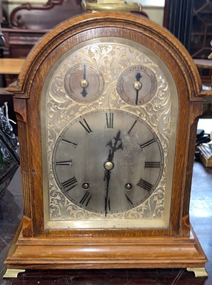 Lot 642 - A late 19th/ early 20th century oak mantle...