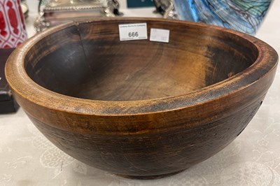 Lot 666 - A turned wooden bowl, with three carved...