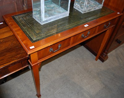 Lot 651 - A reproduction yew wood side table with green...