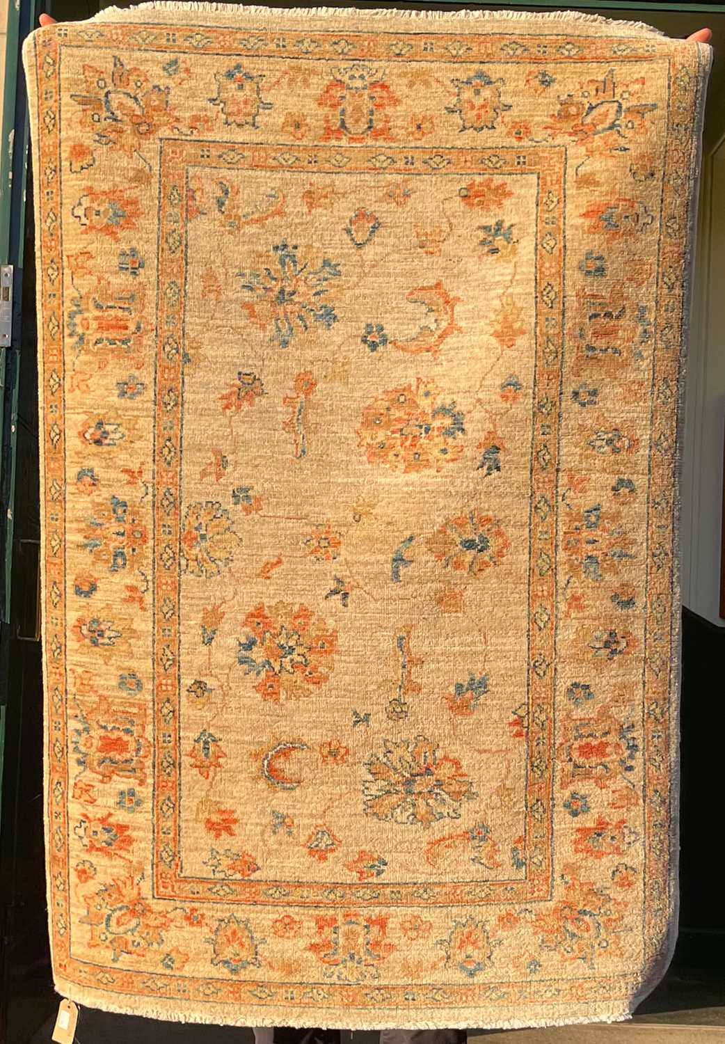 Lot 917 - A small Persian rug, the sand coloured