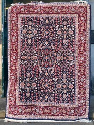 Lot 921 - A Hereke wool rug, the rectangular blue ground...