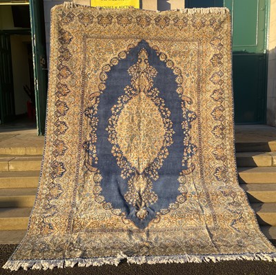 Lot 907 - A blue ground Persian rug, the rectangular...