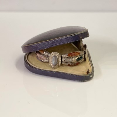 Lot 494B - A Scottish pebble set white metal panel...