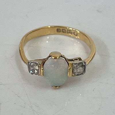 Lot 291J - An 18ct gold opal and diamond three stone ring,...