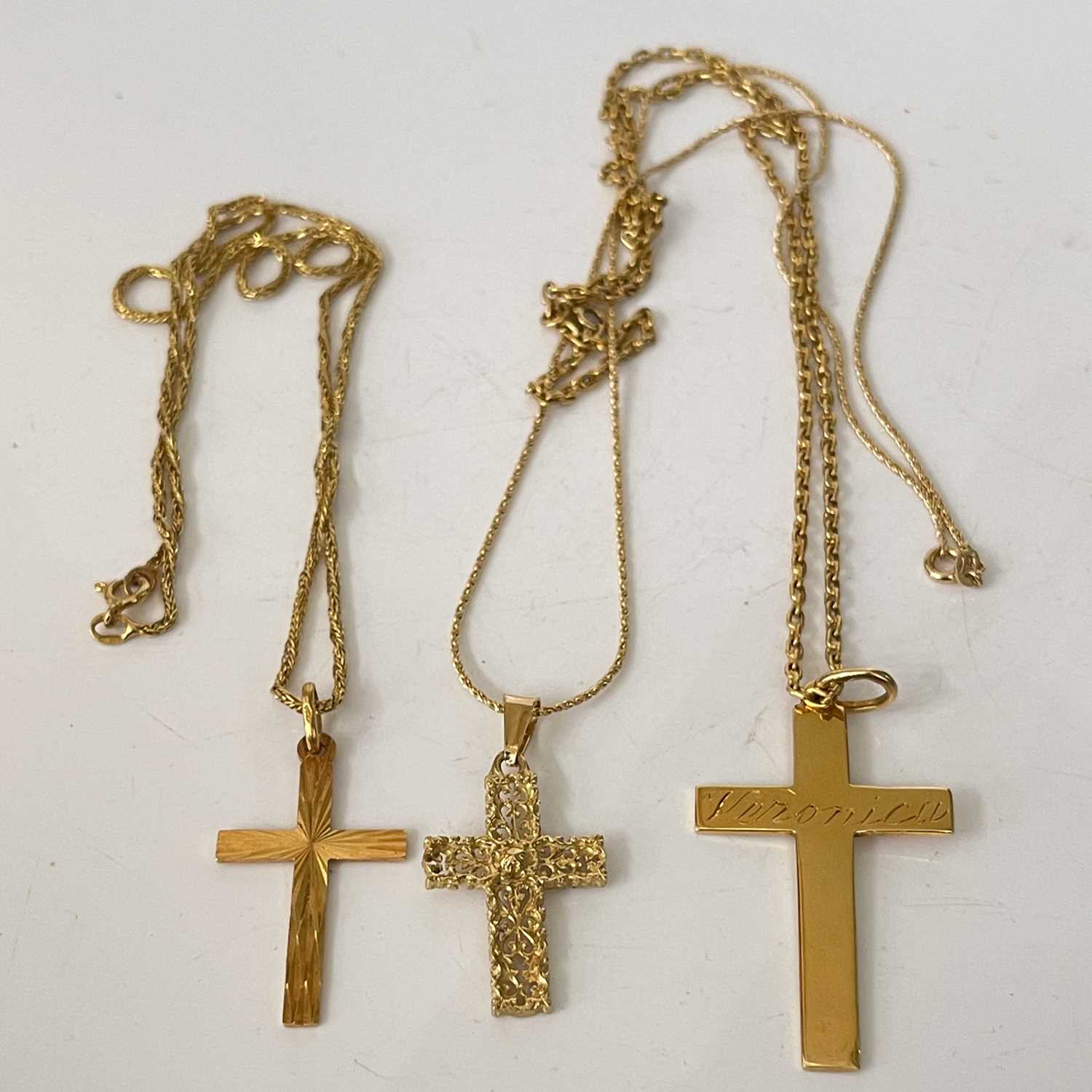 Lot 291 - Three 18ct gold cross pendant necklaces, gross...