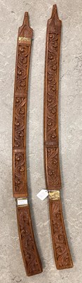 Lot 719 - A pair of Eastern carved wood and brass...