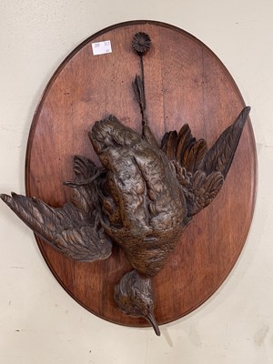 Lot 681A - An oak and bronzed pewter oval wall plaque,...