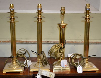 Lot 695 - Three brass table lamps with fluted columns in...