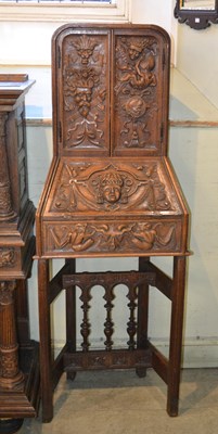 Lot 709 - An antique oak bureau, highly carved depicting...