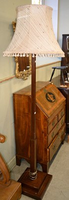 Lot 713 - A 20th century mahogany floor lamp raised on a...