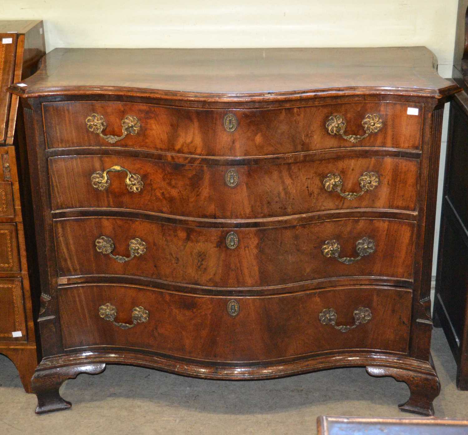 Lot 718 - A George III mahogany serpentine chest, fitted...