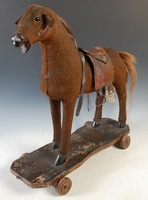 Lot 383 - An early 20th century child's toy horse on...