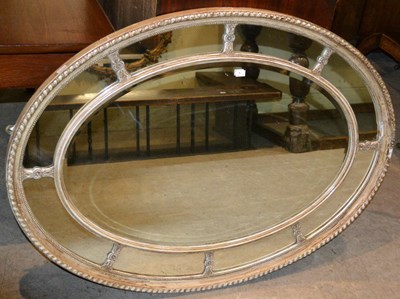 Lot 687 - A Neo Classical style oval gesso wall mirror...