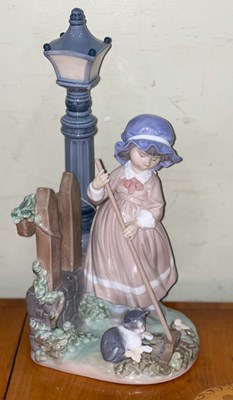 Lot 472 - A Lladro Fall Clean Up porcelain figure...