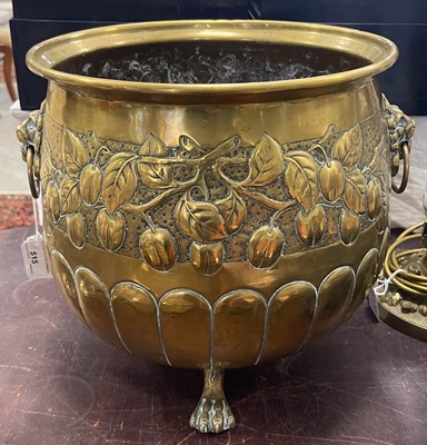 Lot 515 - A large brass planter/ fuel bin decorated with...