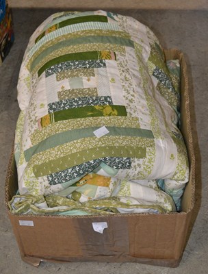 Lot 580 - A large handstitched patch work quilt with...