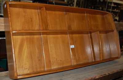 Lot 683 - A vintage Ercol wall shelf with asymetric...