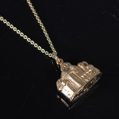 Lot 131 - A yellow metal necklace suspending a yellow...