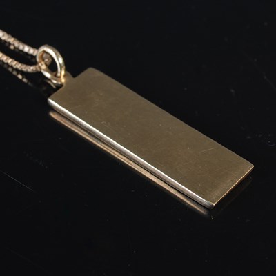 Lot 138 - A 9ct gold necklace suspending a 9ct gold...