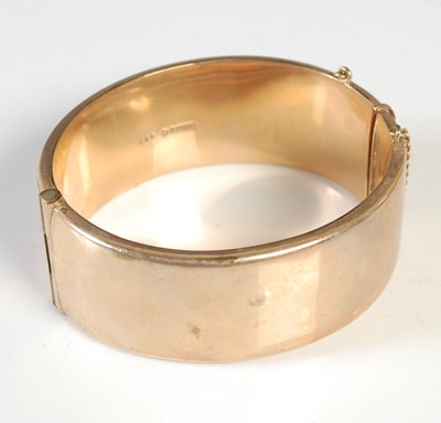 Lot 156 - A 9ct gold hinged bangle, 29.7g.