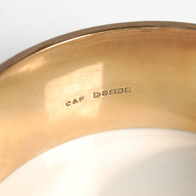 Lot 156 - A 9ct gold hinged bangle, 29.7g.