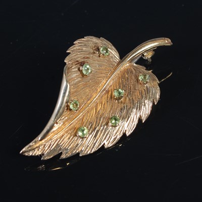 Lot 171 - A 9ct gold and green gemstone set leaf shaped...