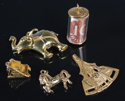 Lot 177 - A group of five gold charms, to include an...