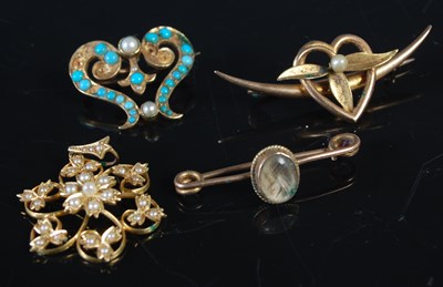Lot 200 - A group of four yellow metal brooches and...