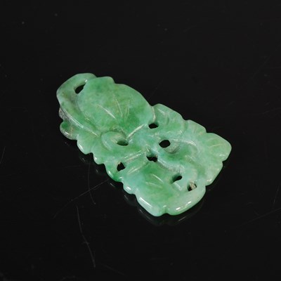 Lot 205 - A jade pendant carved and pierced with foliage,...