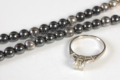 Lot 207 - A single strand pearl necklace with silver...