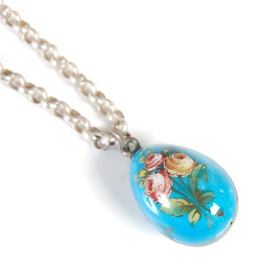 Lot 248 - A silver necklace suspending a blue ground...