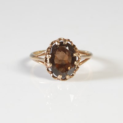 Lot 261 - A 9ct gold and cairngorm set single stone ring,...