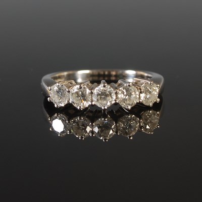 Lot 265 - An 18ct white gold and five stone diamond ring,...
