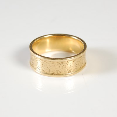 Lot 277 - An 18ct gold ring, the exterior with engraved...