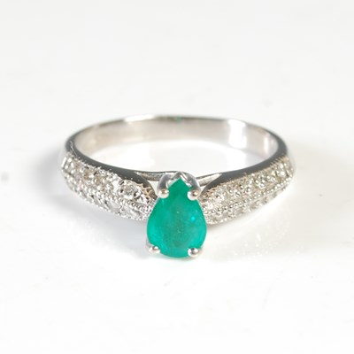 Lot 280 - An 18ct white gold emerald and diamond dress...