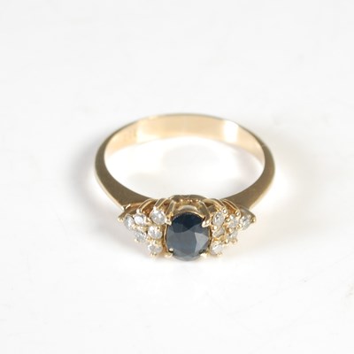 Lot 283 - A yellow metal sapphire and diamond dress ring,...