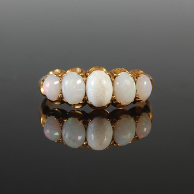 Lot 284 - A yellow metal and opal five stone ring, tests...