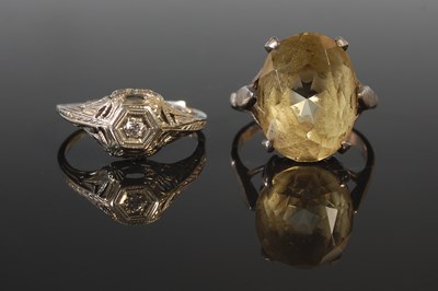 Lot 289 - An 18ct white gold and single stone diamond...