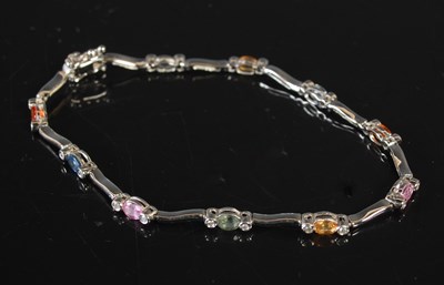 Lot 296 - An 18ct white gold diamond and multicoloured...