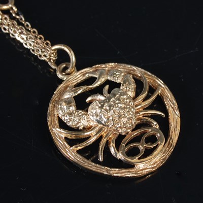 Lot 300 - A 9ct gold pendant, star sign Cancer, on...