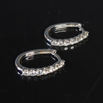 Lot 305 - A pair of 18ct white gold and diamond earrings,...