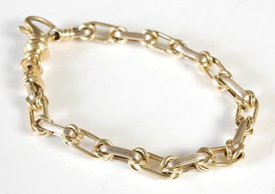 Lot 308 - A two colour gold bracelet, stamped '750',...