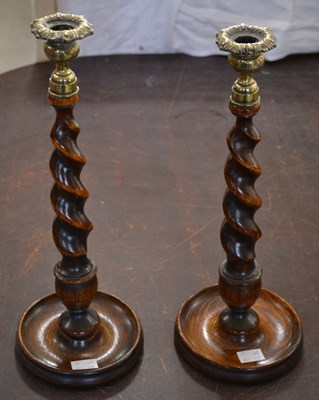 Lot 497 - Two antique oak barley twist candlesticks...