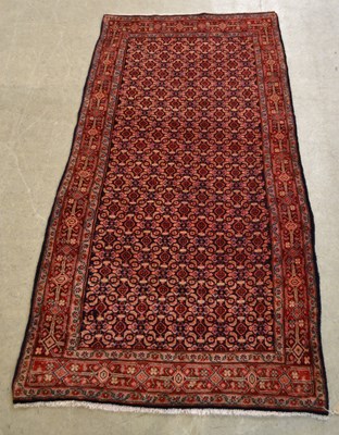 Lot 871 - A Persian Hamedan carpet, the dark blue ground...